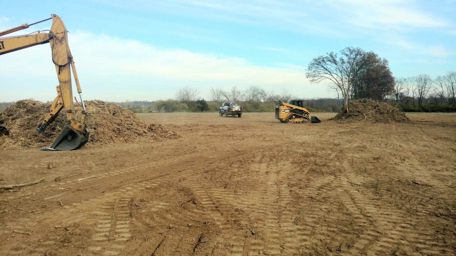 Stockpile of wood chippings being removed